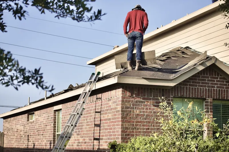 Professional roofer working on a residential roof in Downtown Trenton